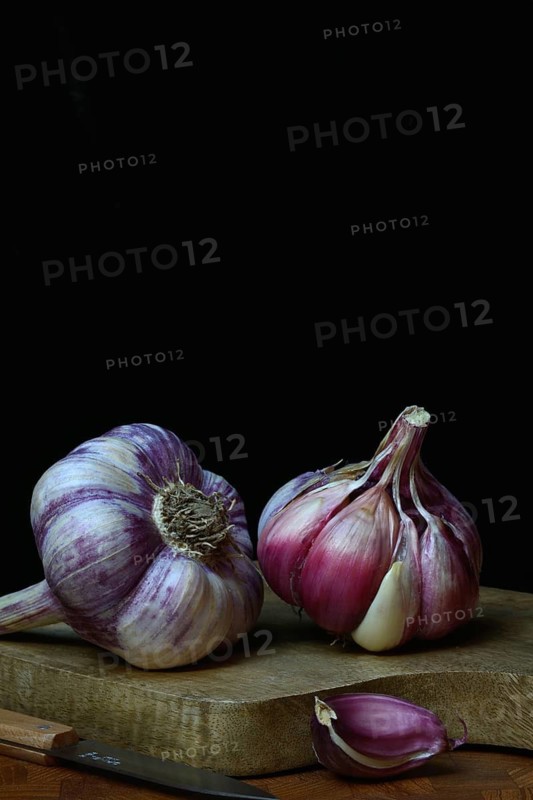 Fresh red garlic on chopping board, France