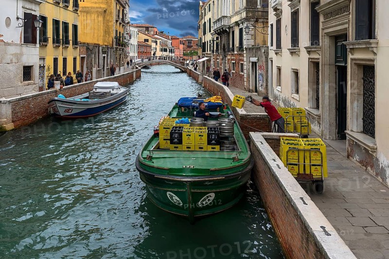 Loading a supply boat on a canal in the old town, Venice, Veneto, Italy