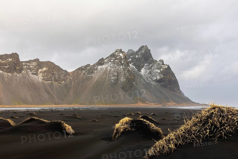 Sand dunes covered with rotten grass, lava sandy beach against mountain backdrop, winter, Stokksnes, Vestrahorn, Klifatindur, Höfn, Iceland, Scandinavia