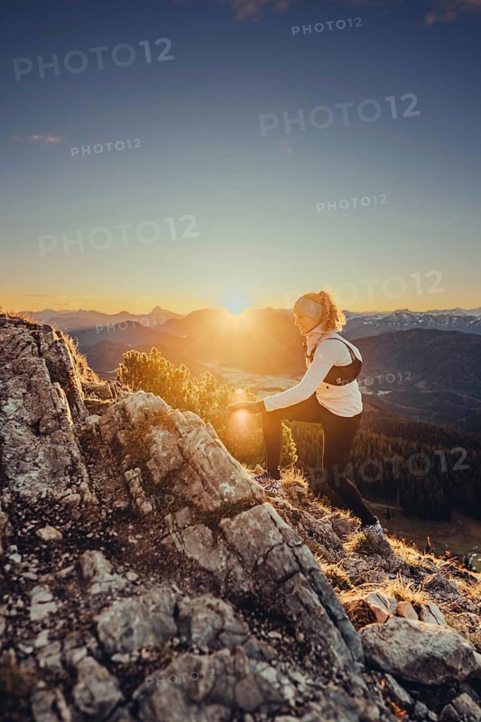 Trail running in autumn on the Jochberg on Lake Walchensee against the wonderful backdrop of the Alps, Bavaria, Germany