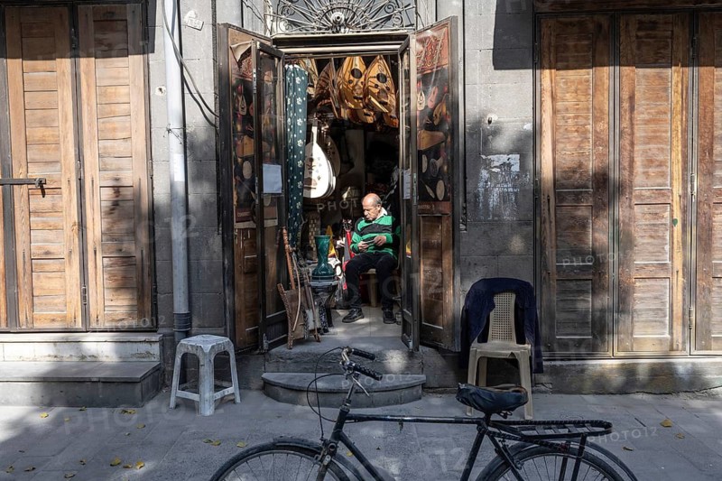 Damascus, Syria. December 5th 2025. A man selling musical instruments in a small shop along The Street Called Straight in Damascus Old City, Syria