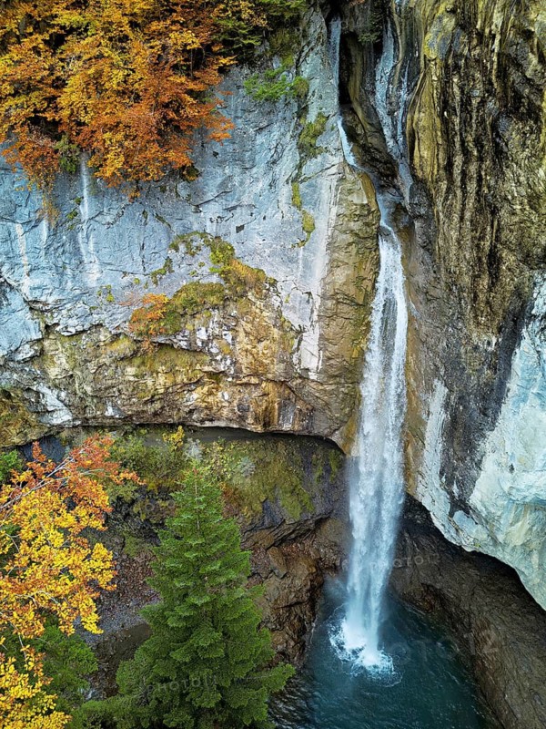 Aerial view of Berglistüber waterfall in autumn-colored surroundings, Linthal, Klausenpass, Canton of Glarus, Switzerland