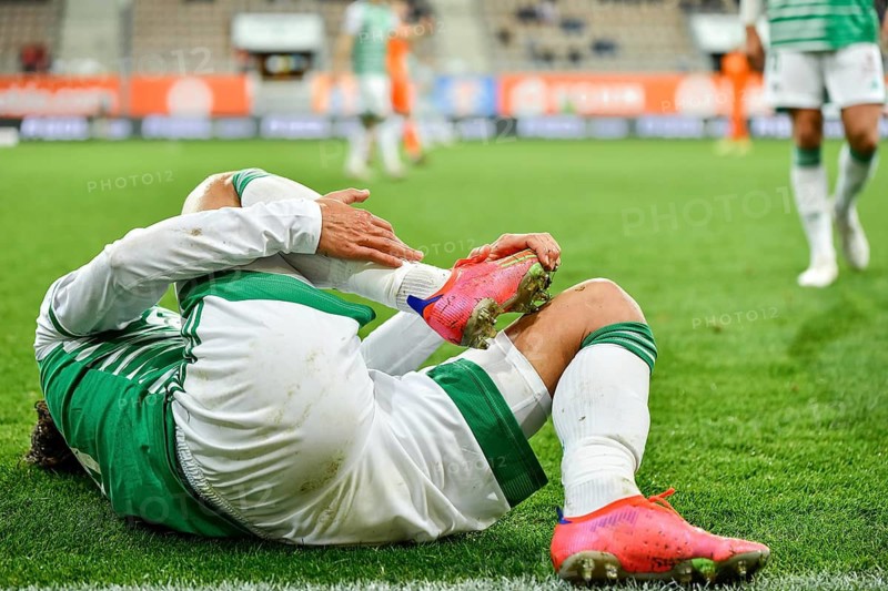 The injured footballer lies on the pitch in Lubin, Poland