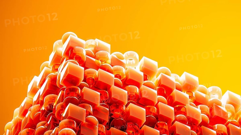 An engaging array of 3D geometric shapes in fiery orange tones combines spheres and cubes, creating a dynamic and visually stimulating design