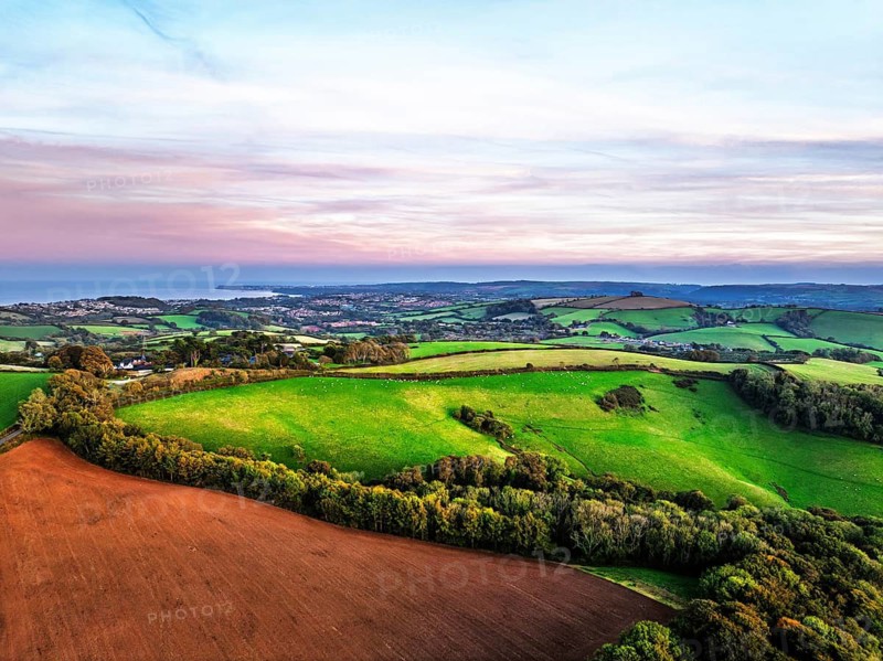 Sunset of Devon Farms and Fields over Berry Pomeroy from a drone, Totnes, England, United Kingdom