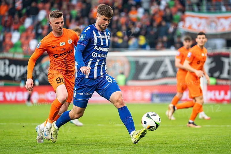 LUBIN, POLAND - APRIL 11, 2025: Football match between KGHM Zaglebie Lubin vs Gornik Zabrze. In action Dawid Kurminowski (L) Kryspin Szczesniak (R)