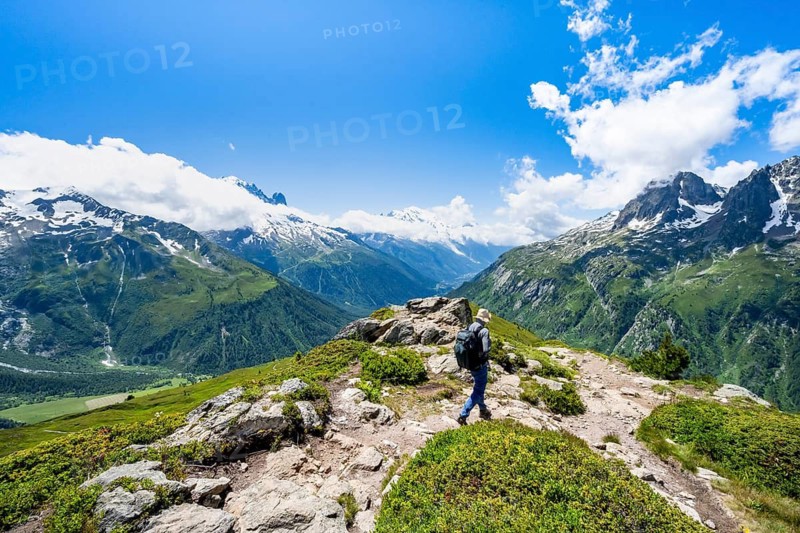 Mountain panorama with glaciated mountain peaks, Aiguille du Midi and Mont Blanc, Aiguille de Mesure and Aiguille de Chamois, mountaineer on hiking trail, hiking to Aiguillette des Posettes, Chamonix, Haute-Savoie, France