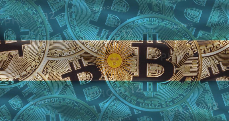 Bitcoin coins on Argentina flag background. Golden bitcoin coins on Argentina flag background