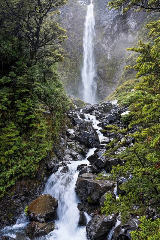 The Devils Punchbowl waterfall falls down a rock face. Arthurs Pass National Park, Canterbury South Island, New Zealand