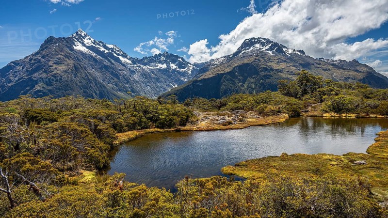 Mountain landscape with lake on the Key Summit Track hiking trail. View of Mount Christina, Mount Crosscut and Mount Lyttle. Fiordland National Park, Southland Region, South Island, New Zealand