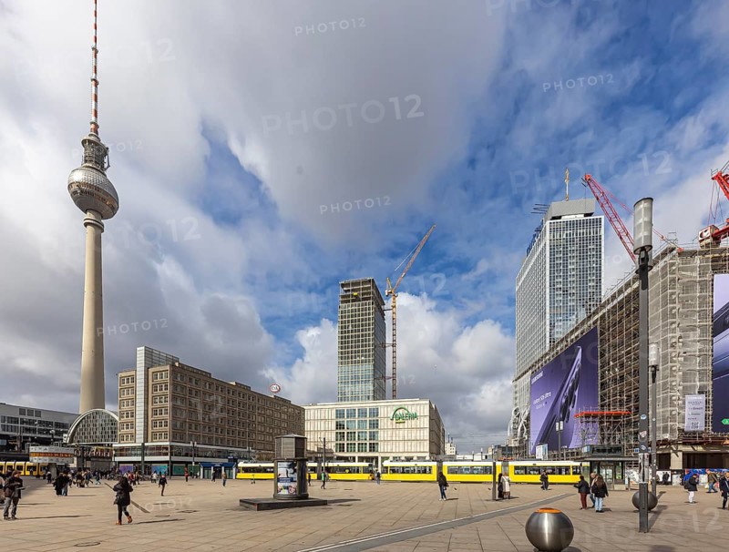 View of Alexanderplatz in Berlin. Covivio Tower and The Berlinian construction sites. Megaposter advertising poster and a tram. TV tower. Berlin, Germany