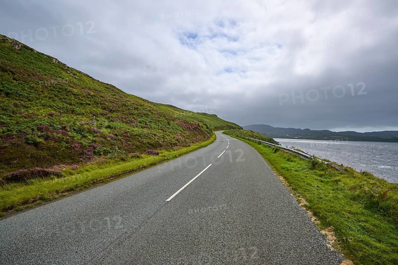 Road along a hill overlooking sea and cloudy sky, Isle of Skye, Scotland, United Kingdom, United Kingdom