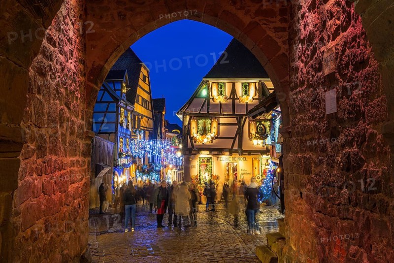 Colour-illuminated and Christmassy decorated half-timbered houses, blue hour, Christmas market, Riquewihr, Grand Est, Haut-Rhin, Alsace, France