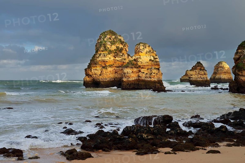 Rock formations on the coast in the evening light, Praia do Camilo, Lagos, Algarve, Portugal