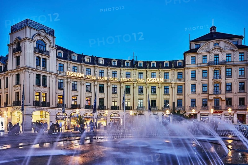 Square, historic commercial building, Karlsplatz roundel, neo-baroque style, architects Gabriel von Seidl and Oscar Strelin, neon sign Osram, bright as light day, fountain, evening blue hour, deep blue evening sky, cloudless, Stachus, Karlsplatz, Munich, state capital, district-free city, Bavaria, Germany