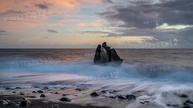 Sunset, waves and rocks in the sea, Praia Formosa, Madeira, Portugal