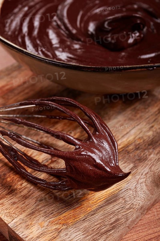 Metal whisk, close-up with chocolate dough, baking, structure and consistency, homemade, top view, no people