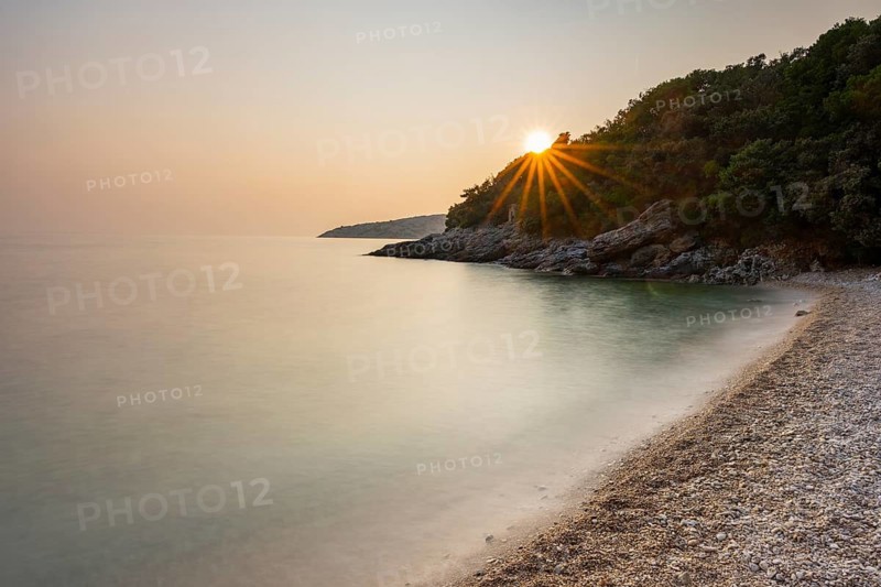 Crystal clear and turquoise water on the beach of Ustrine Bay on a sunny day at sunset on the island of Cres, long exposure, Croatia