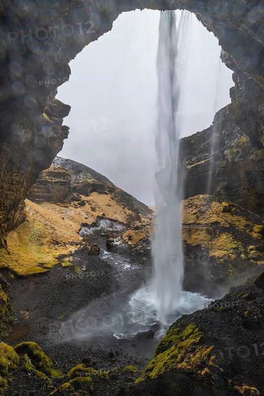 Waterfall from behind, lava rock canyon, winter, Kvernufoss, Skogar, Iceland, Scandinavia