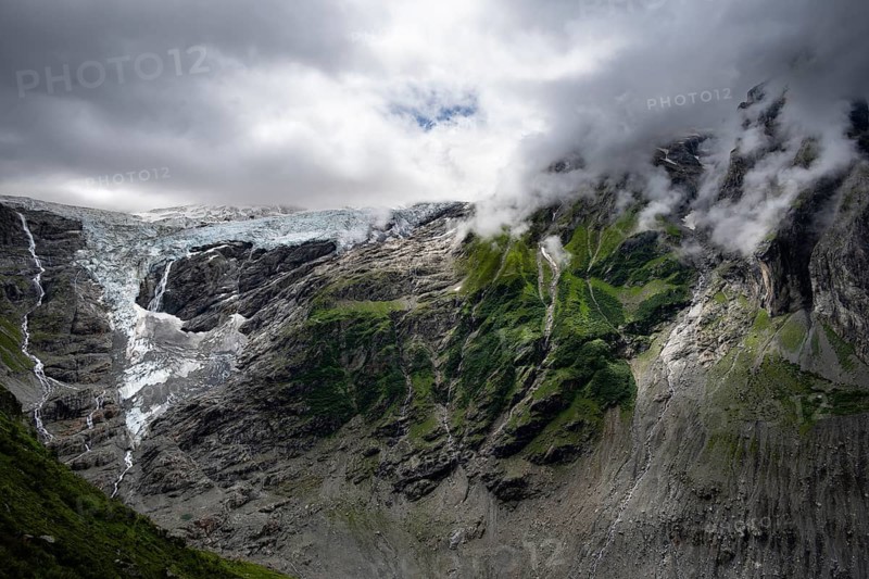 Dramatic mountain landscape covered in clouds with Grindelwald-Fiescherfirn glacier, Bernese Alps, Bernese Oberland, Switzerland