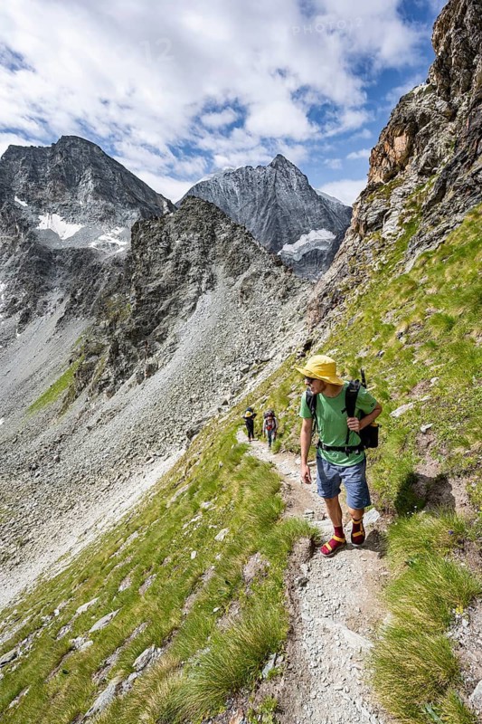 Mountaineer on a hiking trail, mountain landscape, ascent to Col de Riedmatten, behind summit Mont Blanc de Cheilon, Valais, Western Alps Switzerland