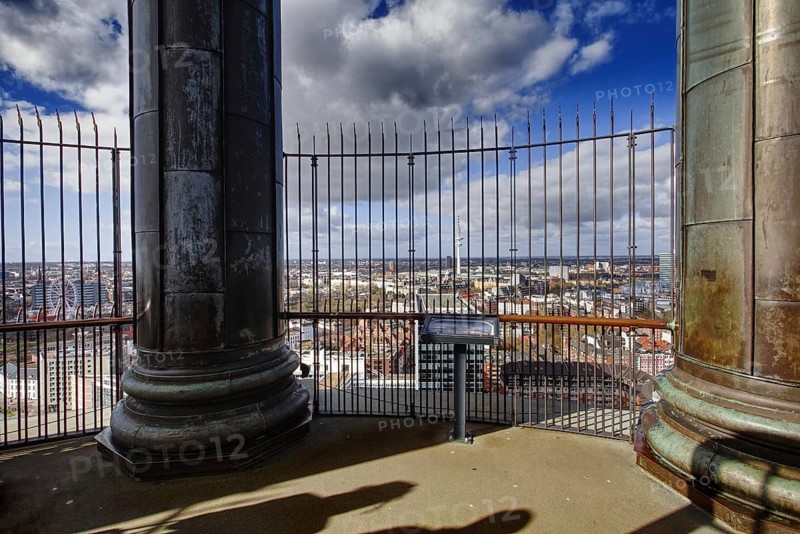 View from the viewing platform of Hamburger Michels over the urban landscape, fenced and under a blue sky, Hamburg, Germany
