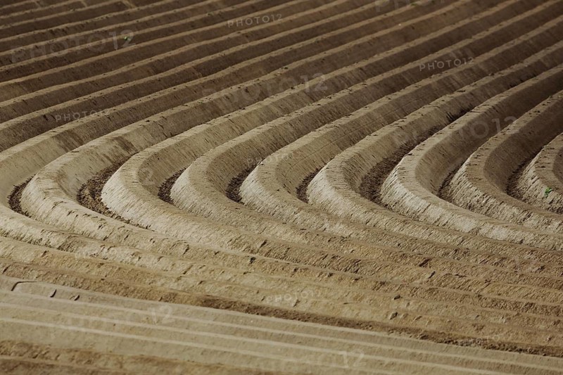 Deep tall fields in brown fields, ditches with geometric furrows, parallel brown traces in the field, monochrome backgrounds, regular ones with round corners, curves, structure, pattern, curvature, bend, change of direction, field crumb, agriculture, Oosterend, Texel, North Holland, the Netherlands