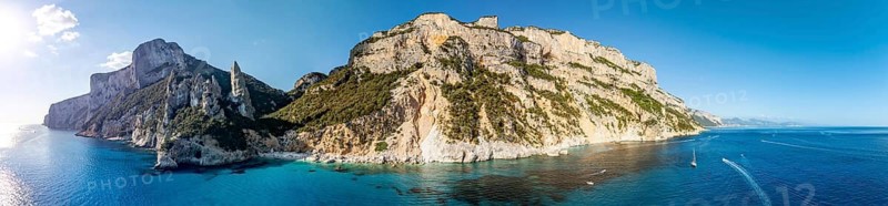 Panorama, picturesque rocky coast, cliffs with L'Aguglia pinnacle, blue sea and Cala Goloritzé beach, aerial view, Golfo di Orosei, Baunei, Sardinia, Italy