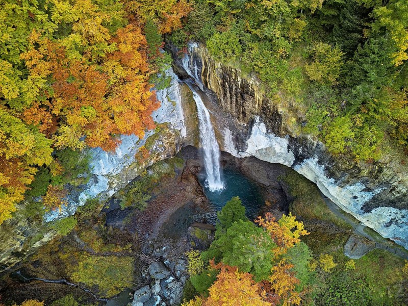 Aerial view of Berglistüber waterfall in autumn-colored surroundings, Linthal, Klausenpass, Canton of Glarus, Switzerland