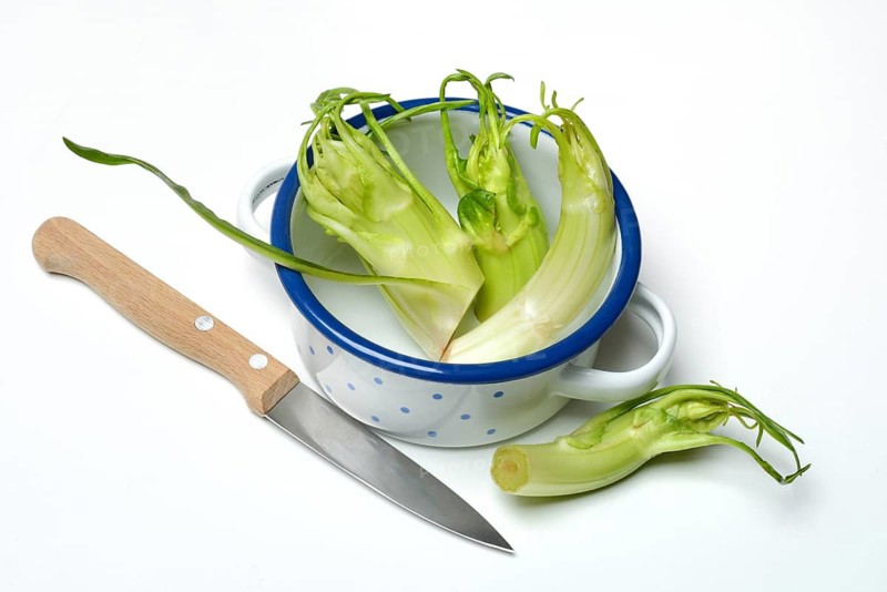 Puntarelle in bowl with knife, asparagus chicory