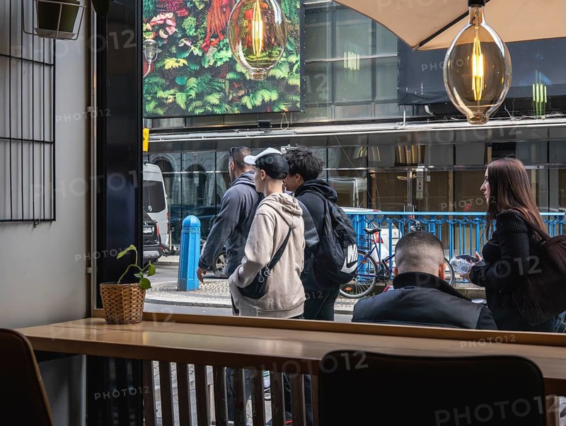 View through the window of a café of passers-by on Friedrichstraße in Mitte, Berlin, Germany