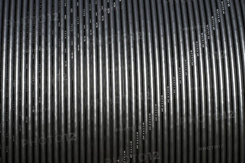 Black broadband cable on a spool, Oberweser, Weser Uplands, Weserbergland, Hesse, Germany