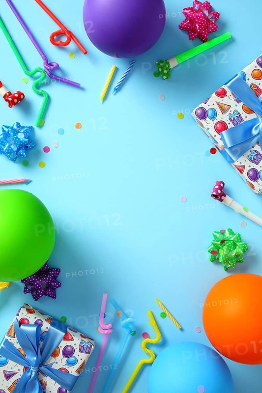 Colorful birthday party flat lay with balloons and gifts on blue background