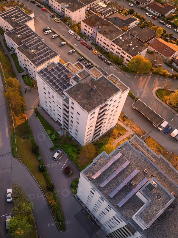 Bird's-eye view of residential buildings with parked cars and streets at sunset, urban atmosphere, Nagold, district of Calw, Germany