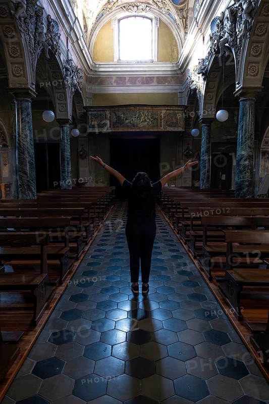 Woman Standing with Arms Outstretched Inside the Beautiful Church in Switzerland
