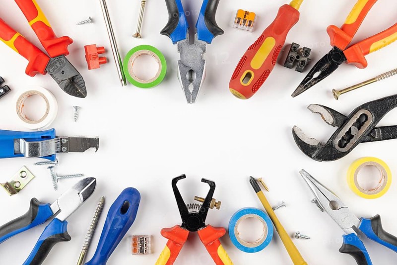 Colorful tools, tape, screws and cable connectors in circle shape on white background
