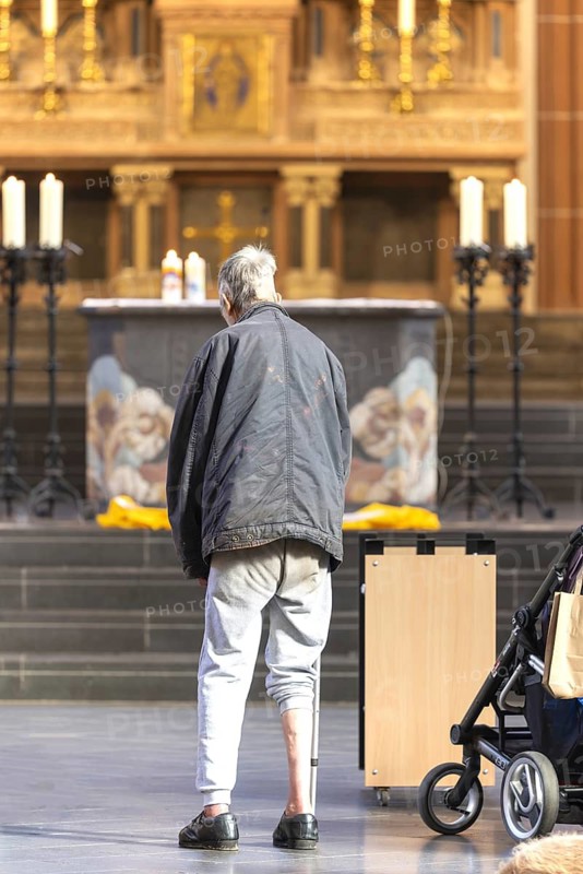 A mentally confused homeless man in the church, family mass with blessing of animals in St Agnes, Agneskirche, Cologne, North Rhine-Westphalia, Germany
