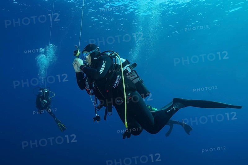 Two divers at a safety stop underwater surrounded by deep blue, Giens Peninsula dive site, Mediterranean Sea, Porquerolles, Provence, Côte d'Azur, France