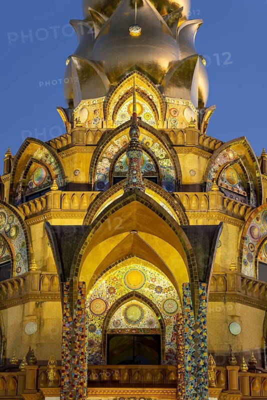 Main chedi (Phra That) decorated with over 5 million colourful mosaic stones and ceramic pieces, at sunset, Buddhist temple complex Wat Phra That Sorn Kaew, Phetchabun province, Thailand