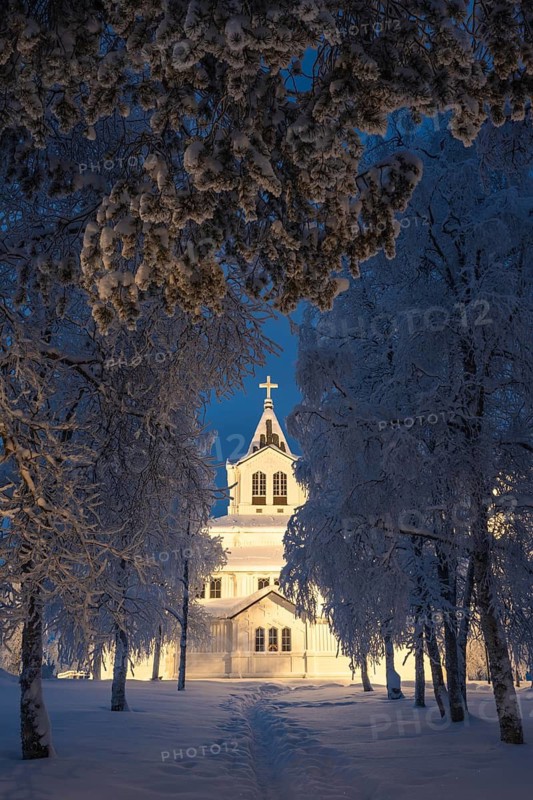 Illuminated wooden church in snow, Gällivare, Norrbotten, Lapland, Sweden, December 2023
