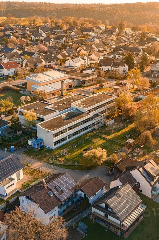School and residential buildings with solar panels in an autumn landscape, Schlehengäuschule, Gechingen, Hecken and Gäu region, Calw district, Germany