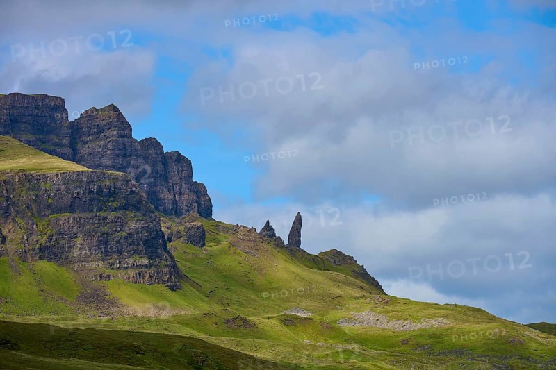 Green hills with eye-catching rock formations against a blue sky with clouds, Old Man of Storr, Portree, Isle of Skye, Scotland, United Kingdom, Great Britain