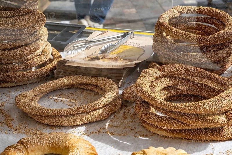 Traditional sesame seed bagels known as koulouria in Greek are a popular street food snack sold from street carts and bakeries, a typical breakfast food in Greece