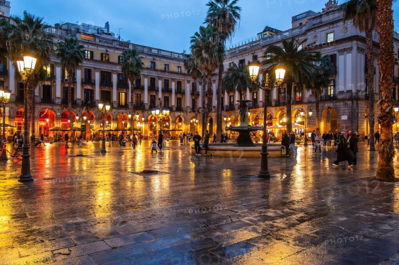 Nightlife at Plaça Reial, lanterns by Gaudi in the historic centre of Barcelona, Spain