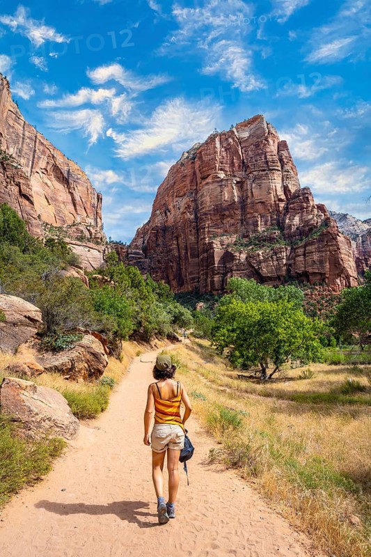 A young woman starting the trekking climb of the Angels Landing Trail in Zion National Park, Utah. United States, vertical photography