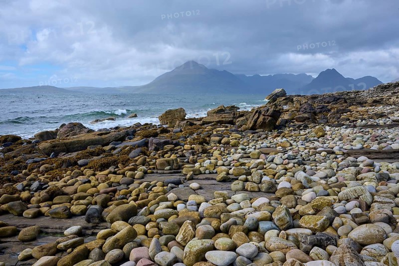Pebble beach with waves, view of mountains in background and cloudy sky, Elgol Beach, Elgol, Isle of Skye, Scotland, United Kingdom, Great Britain