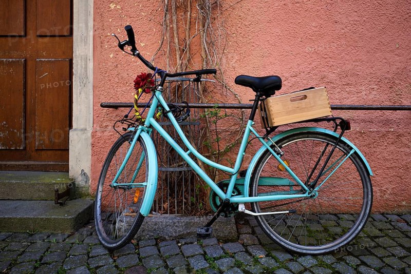 Women's bicycle, bicycle, turquoise, leaning against house wall, pink, Lindau, Bavaria, Lake Constance, Germany