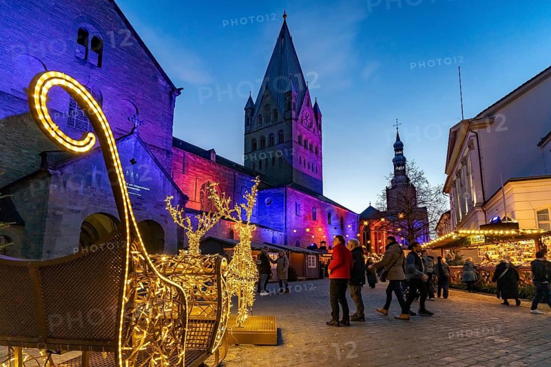 LED reindeer with sleigh at the Christmas market and St. Patrokli Cathedral in Soest at dusk, North Rhine-Westphalia, Germany
