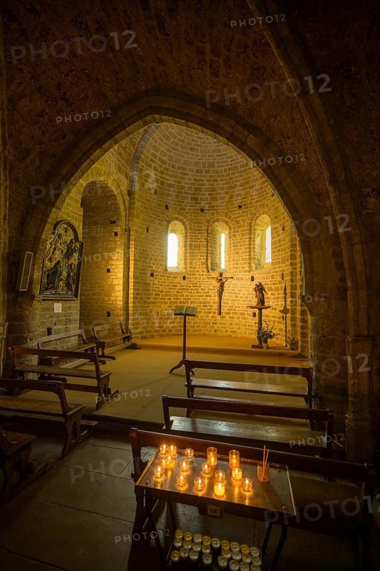 Side chapel with burning candles in the Abbey of Gellone, also Saint-Guilhem-le-Désert Monastery, Département Hérault, France
