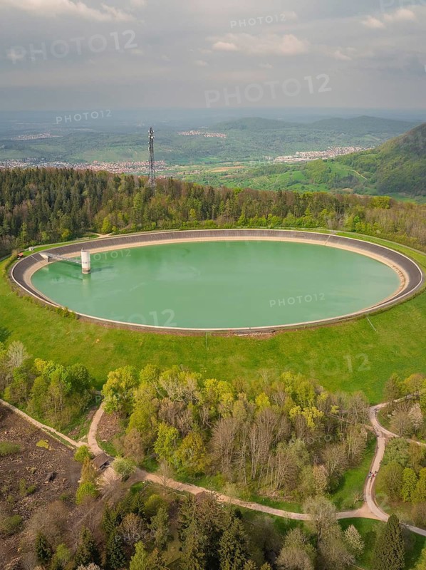 Upper reservoir, large round reservoir in wooded landscape with wide views, Glems reservoir, Swabian Alb, Germany